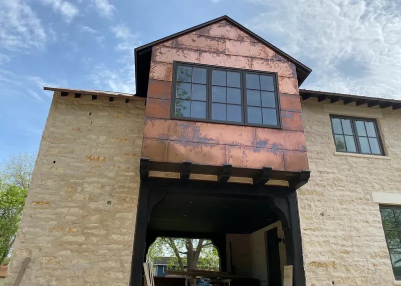 Copper metal panel facade on a stone building for Roof Repair in Muskogee