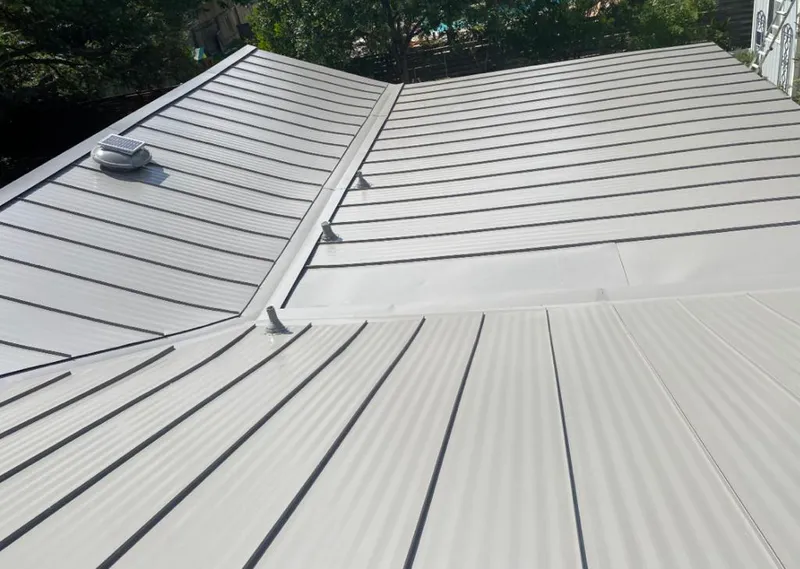 Solar attic fan installed on a metal roof for Roof Ventilation in Muskogee